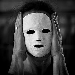 woman holding mask to face