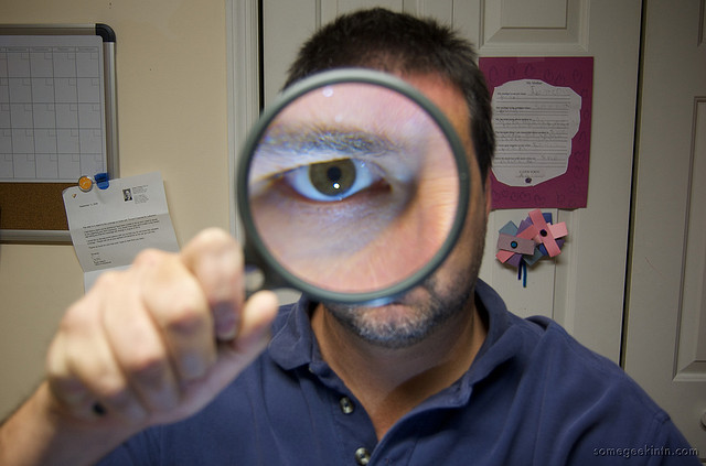 man using magnifying glass