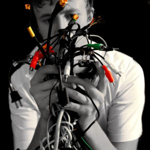 man holding tangle of computer cables