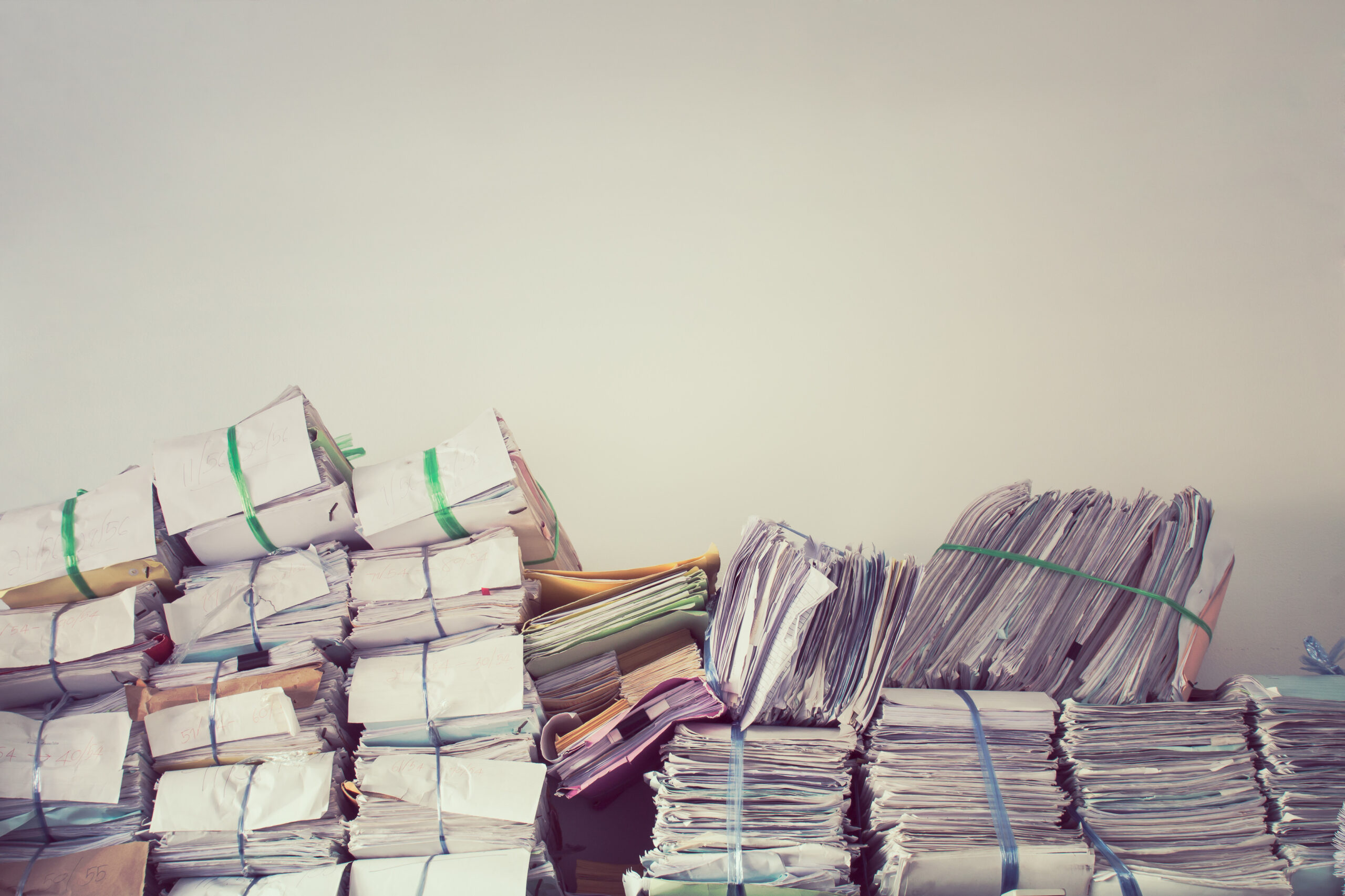 Stack of business report paper files on the document racks in vintage style.